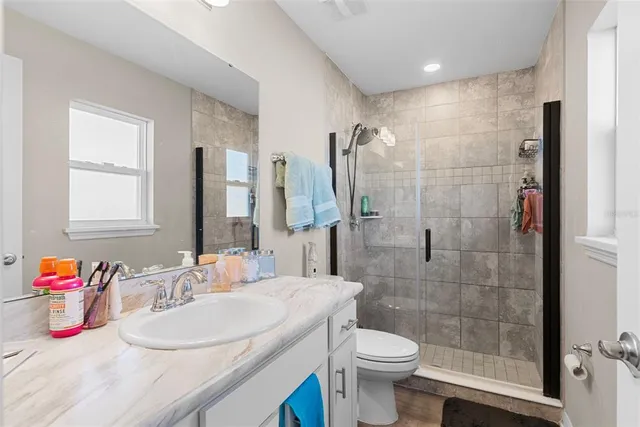 a bathroom with a sink toilet and shower