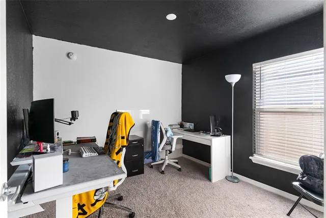 a view of a workspace with furniture and a window