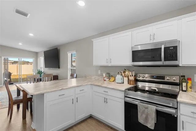 a kitchen with a sink stove and microwave