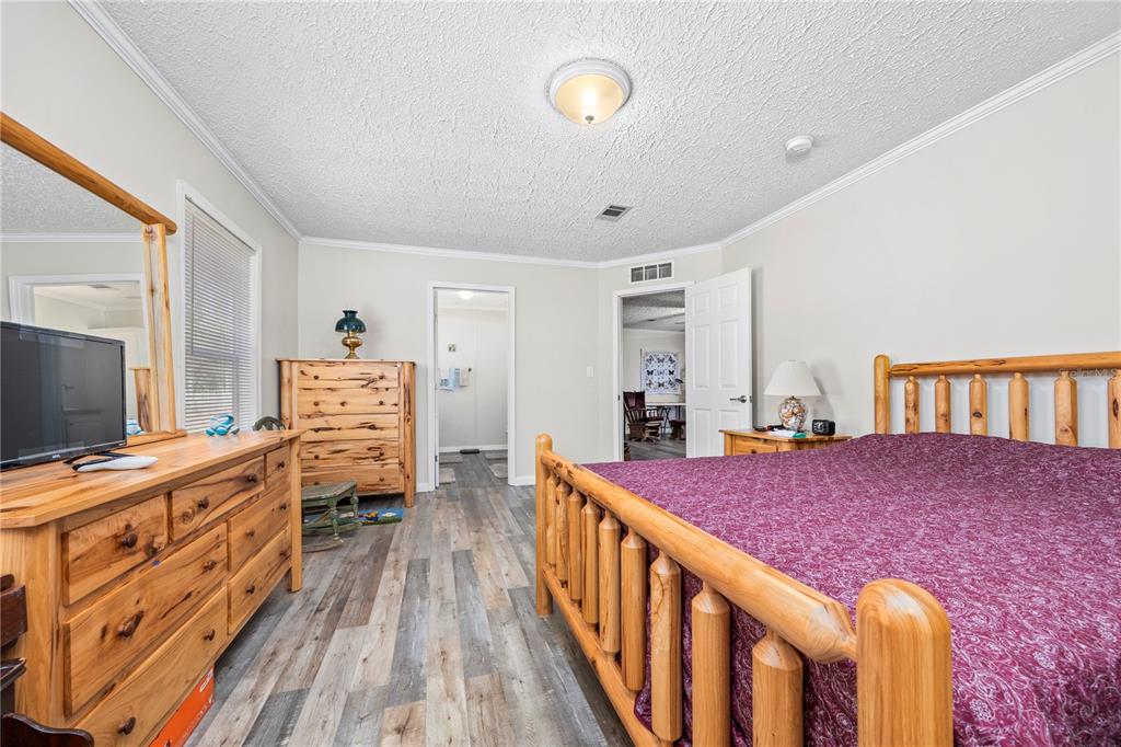 3964 288th Street Branford, FL 32008 - Photo 13 of 37 a bedroom with furniture and a flat screen tv