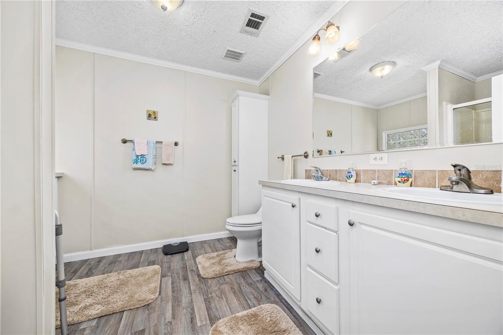 3964 288th Street Branford, FL 32008 - Photo 15 of 37 a spacious bathroom with a double vanity sink and a mirror
