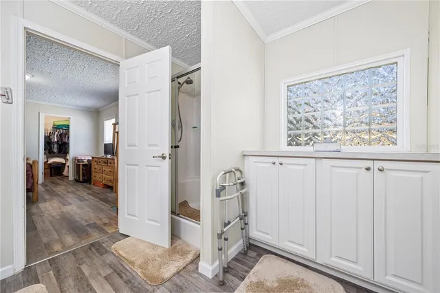 a view of a hallway with closet and a window