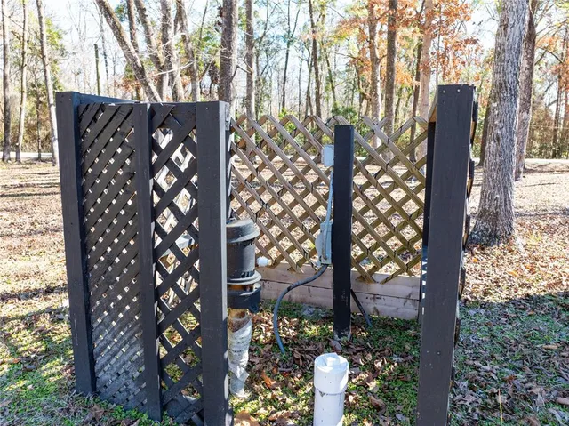 a view of a wooden fence under a large tree