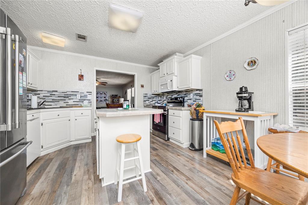 3964 288th Street Branford, FL 32008 - Photo 8 of 37 a kitchen with wooden floors and appliances