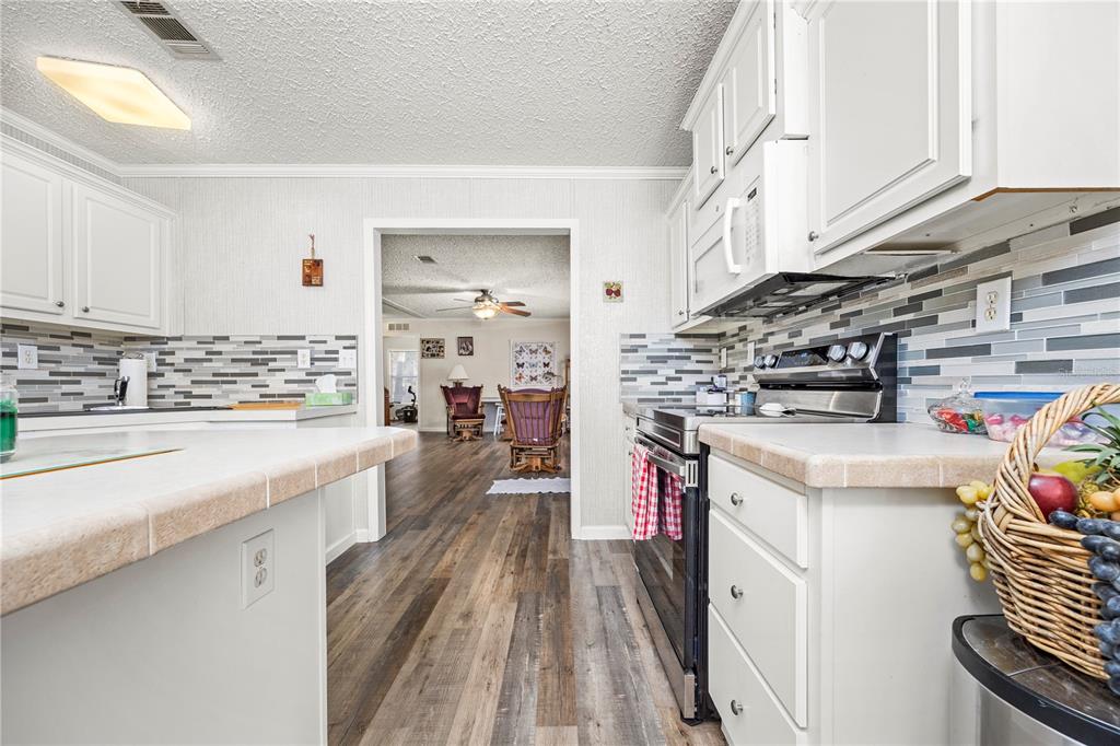 3964 288th Street Branford, FL 32008 - Photo 10 of 37 a kitchen with stainless steel appliances a stove a sink and a refrigerator