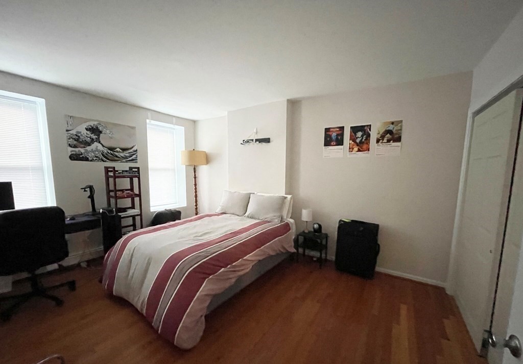 90 Hammond Street, Unit 5 Boston, MA 02120 - Photo 3 of 6 a bedroom with a bed and a chair in it