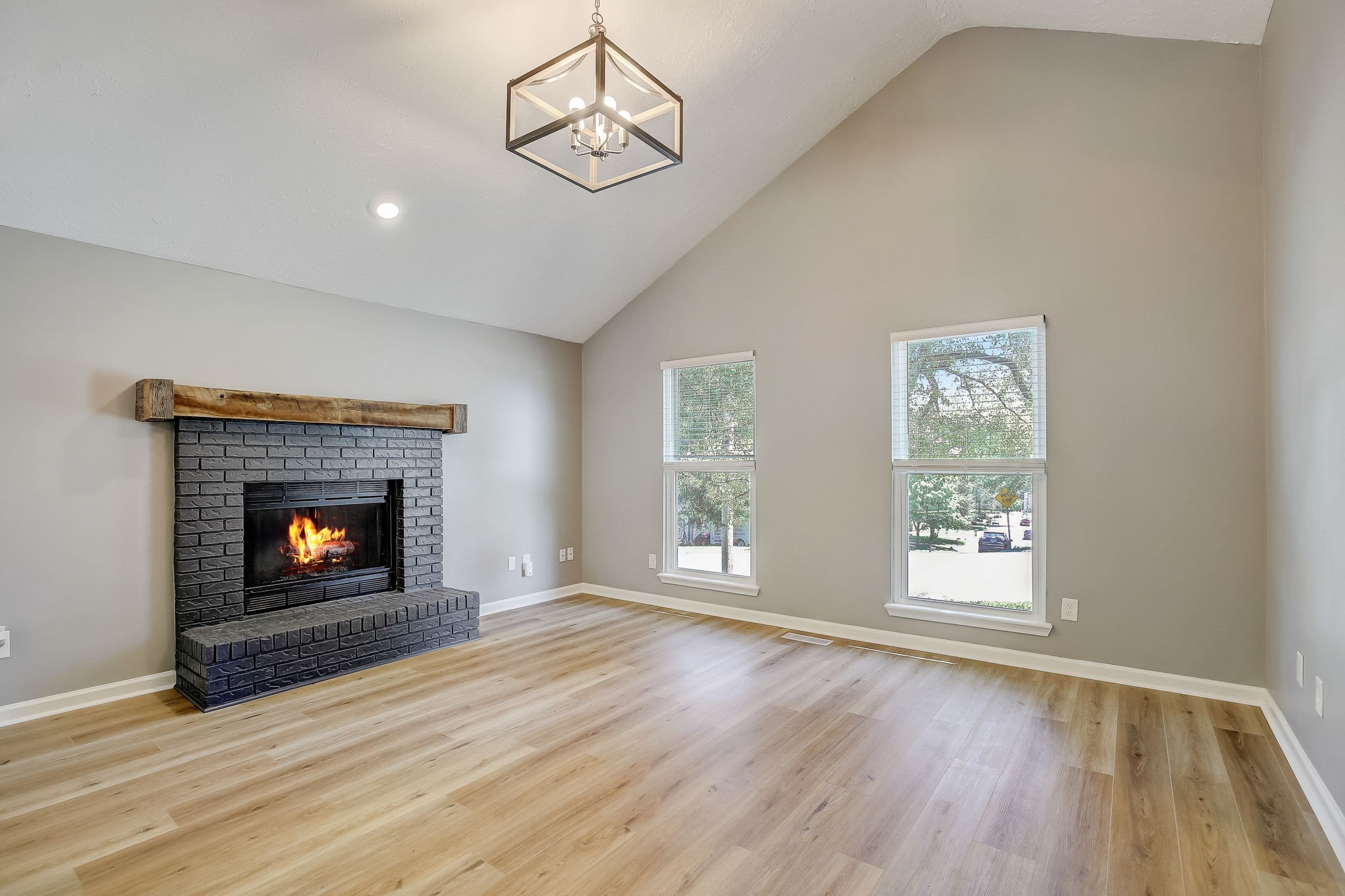 861 Bishopsgate Road Antioch, TN 37013 - Photo 4 of 33 an empty room with windows fireplace and wooden floor