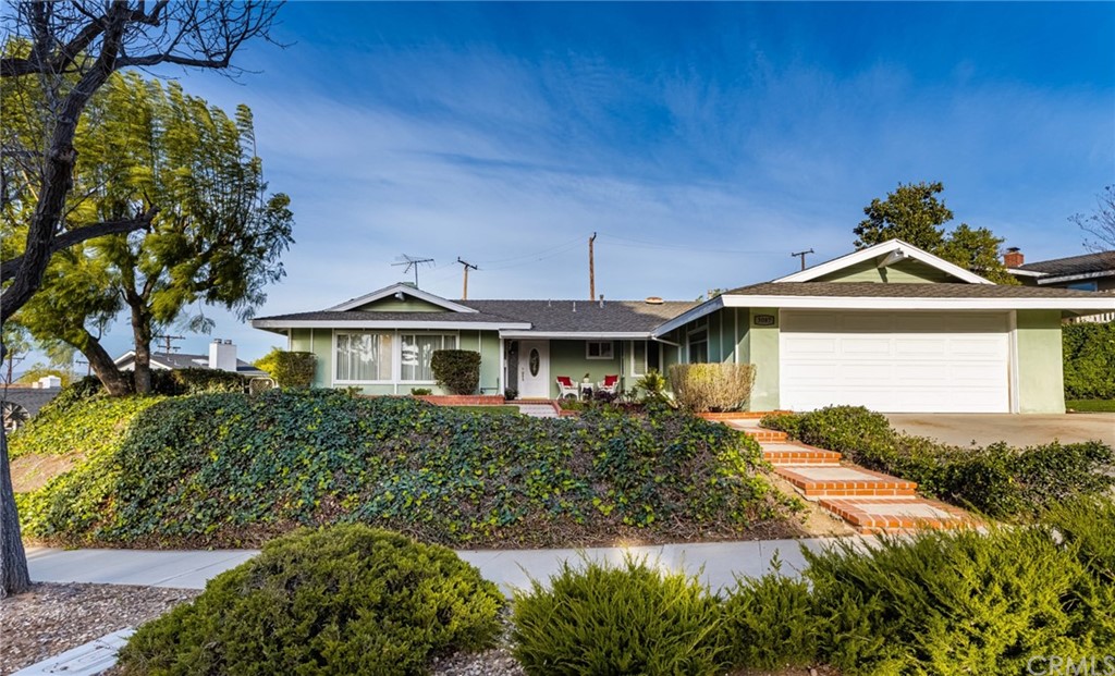 3087 North Butterfield Road Orange, CA 92865 - Photo 1 of 1 a front view of a house with a yard