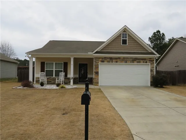 a front view of a house with glass windows and yard