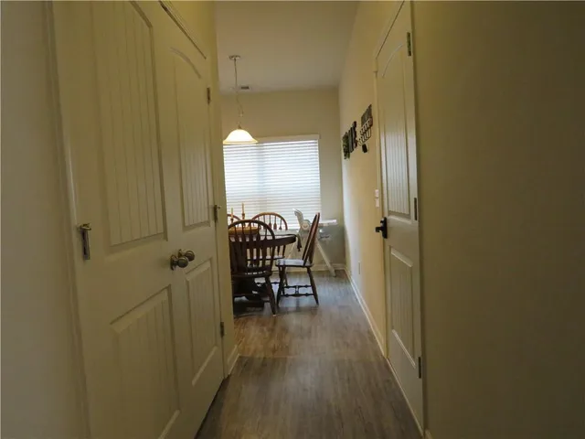 a view of a room with wooden floor