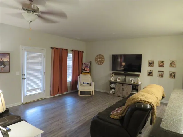a view of a hallway with wooden floor and closet