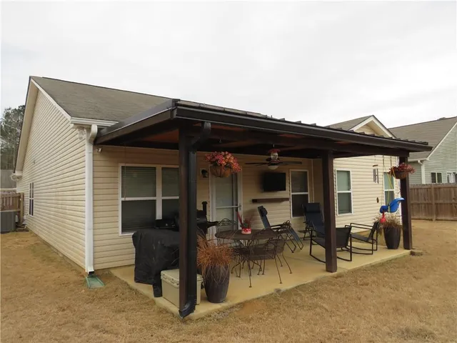 a backyard of a house with outdoor seating