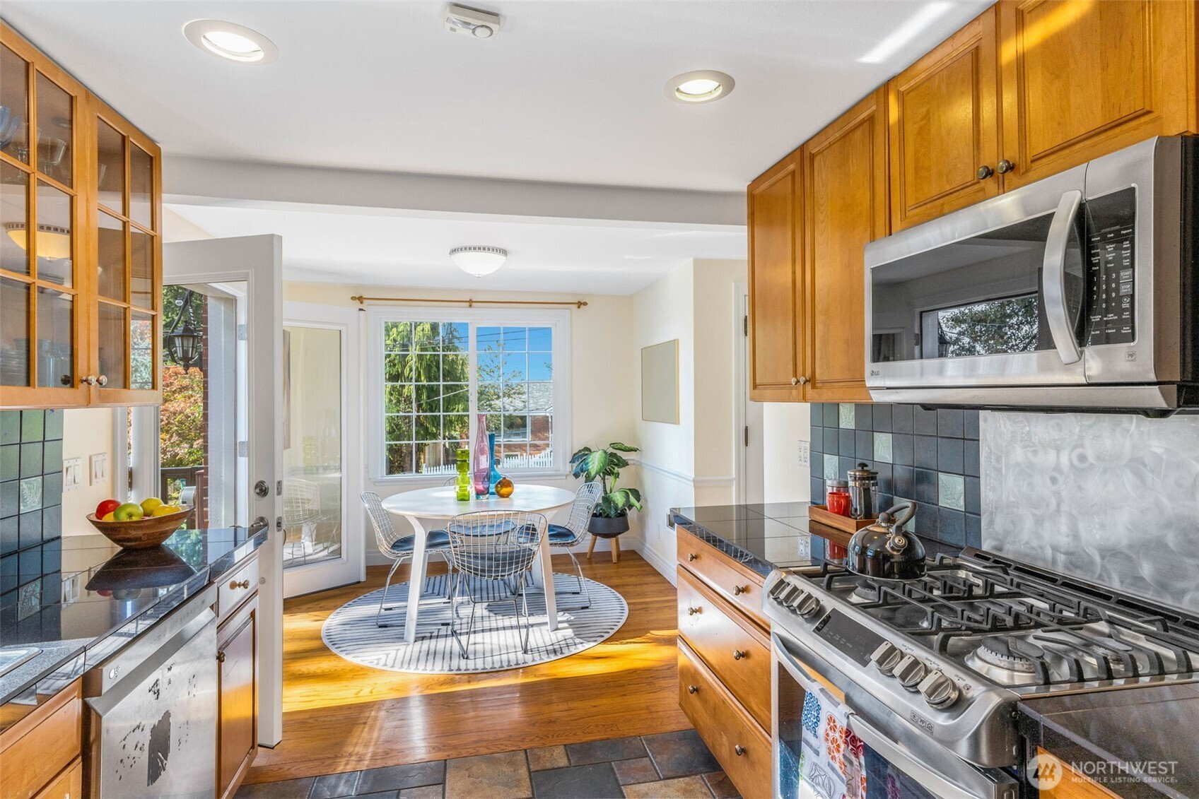 8254 Bagley Avenue North Seattle, WA 98103 - Photo 11 of 21 a kitchen with stainless steel appliances granite countertop a stove a sink and a granite counter tops with a large window