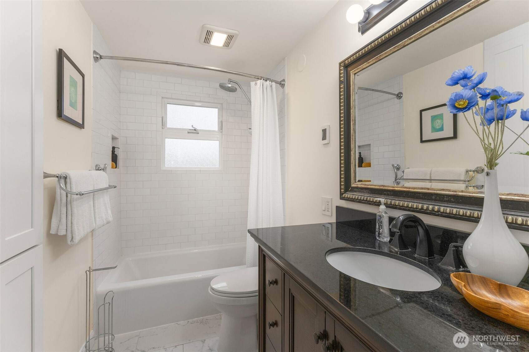 8254 Bagley Avenue North Seattle, WA 98103 - Photo 13 of 21 a bathroom with a granite countertop sink mirror vanity and toilet