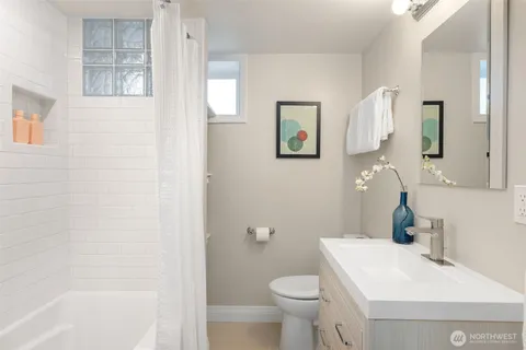 a bathroom with a sink toilet and shower