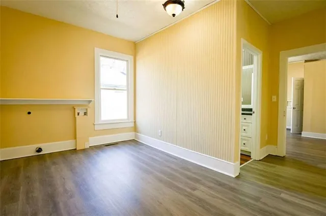 a view of a room with wooden floor and bathroom
