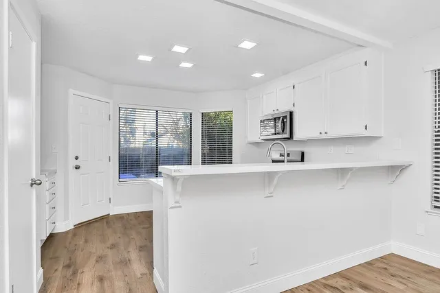 a kitchen with a stove a sink and a microwave