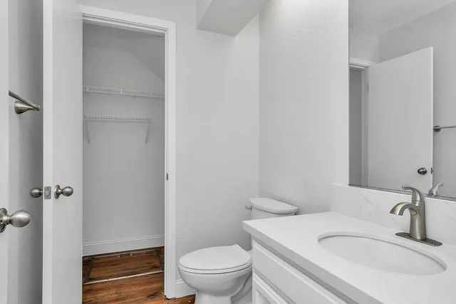 a view of an entryway with wooden floor and a fireplace