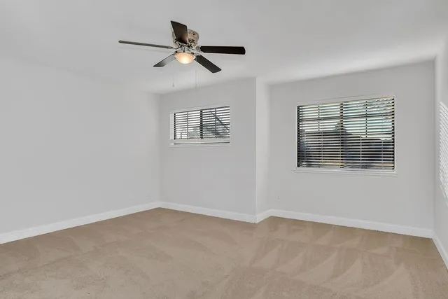 a view of a livingroom with a ceiling fan and entryway