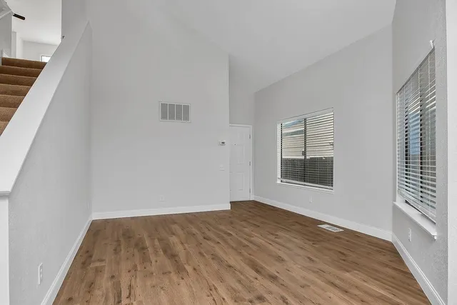 a living room with a fireplace and a ceiling fan