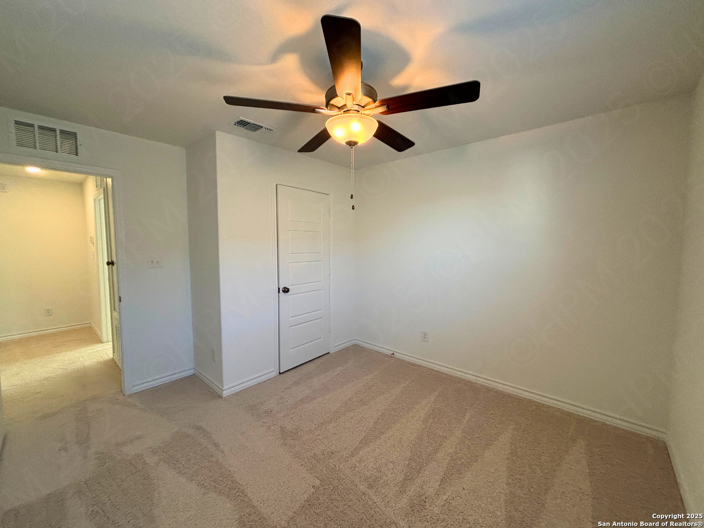 1032 Oriole Way Marion, TX 78124 - Photo 12 of 18 an empty room with closet and chandelier fan