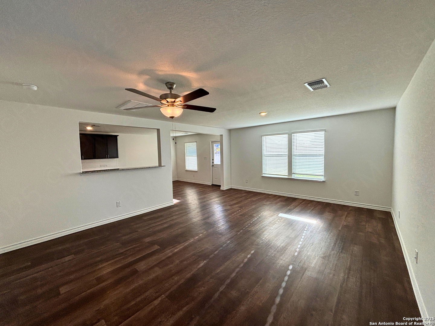 1032 Oriole Way Marion, TX 78124 - Photo 4 of 18 an empty room with wooden floor and windows