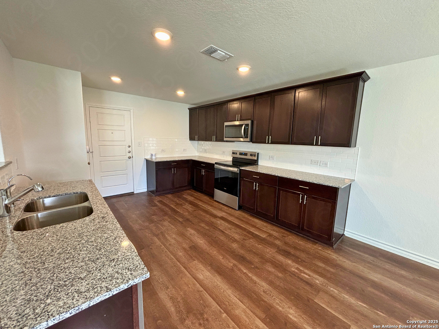 1032 Oriole Way Marion, TX 78124 - Photo 6 of 18 a large kitchen with stainless steel appliances granite countertop a sink stove and refrigerator