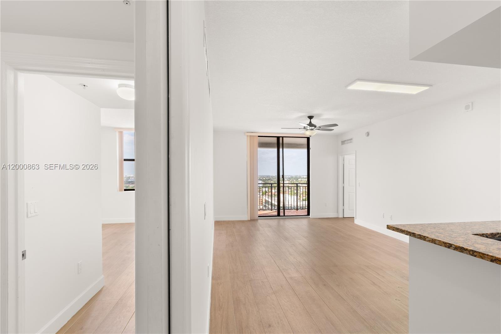888 Douglas Road, Unit PH01 Coral Gables, FL 33134 - Photo 11 of 31 a view of a room with an entryway and wooden floor
