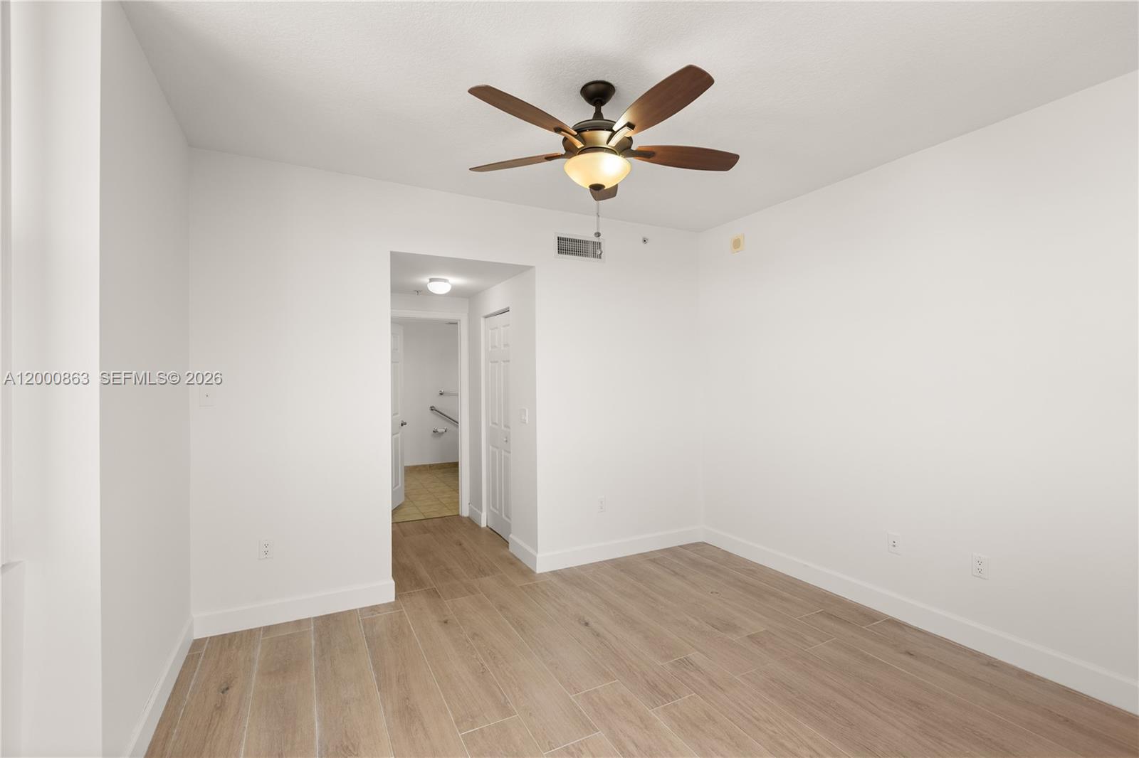 888 Douglas Road, Unit PH01 Coral Gables, FL 33134 - Photo 22 of 31 a view of an empty room with wooden floor