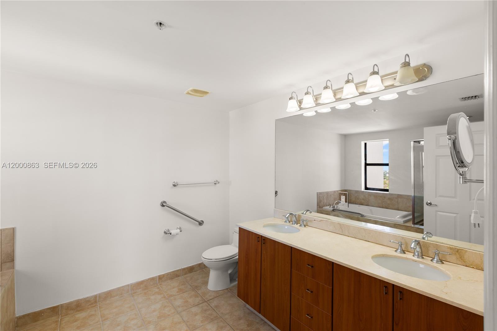 888 Douglas Road, Unit PH01 Coral Gables, FL 33134 - Photo 26 of 31 a bathroom with a double vanity sink mirror and toilet