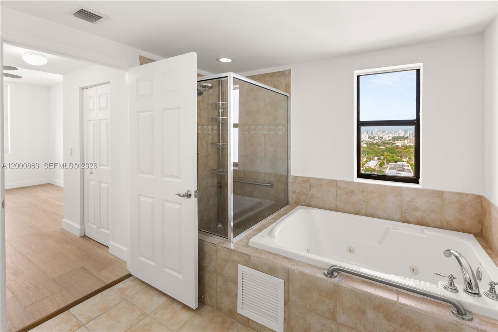 888 Douglas Road, Unit PH01 Coral Gables, FL 33134 - Photo 27 of 31 a bathroom with a tub and a view of bathroom