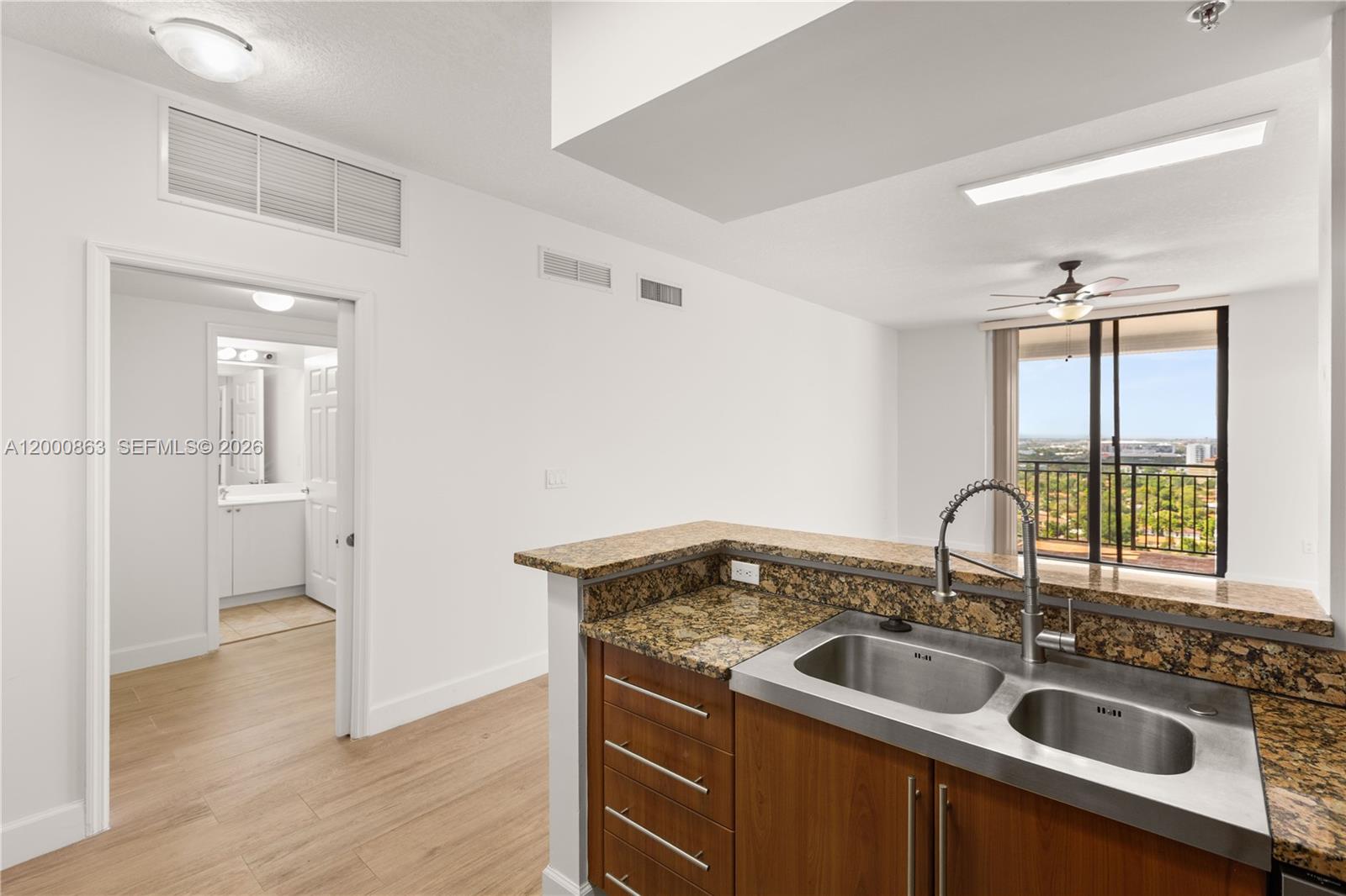 888 Douglas Road, Unit PH01 Coral Gables, FL 33134 - Photo 10 of 31 a kitchen with a sink and a window