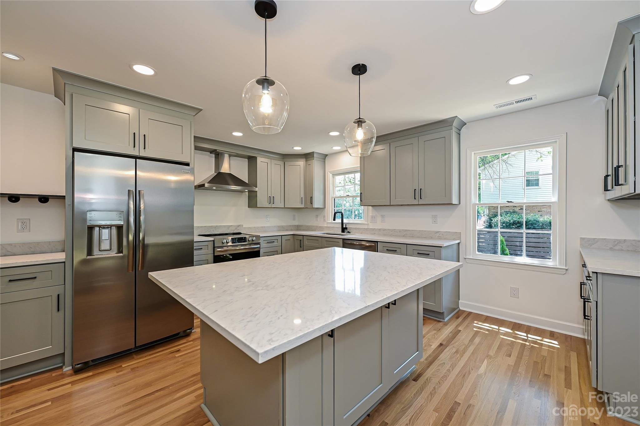 5024 Providence Road Charlotte, NC 28226 - Photo 15 of 39 a kitchen with a refrigerator a sink and wooden floor