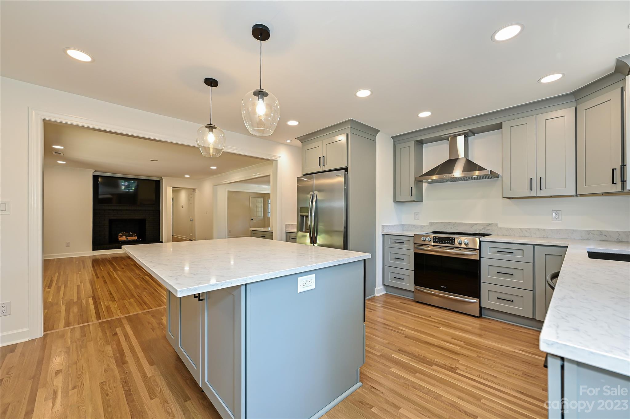 5024 Providence Road Charlotte, NC 28226 - Photo 19 of 39 a large kitchen with granite countertop a stove top oven a sink a counter space and cabinets