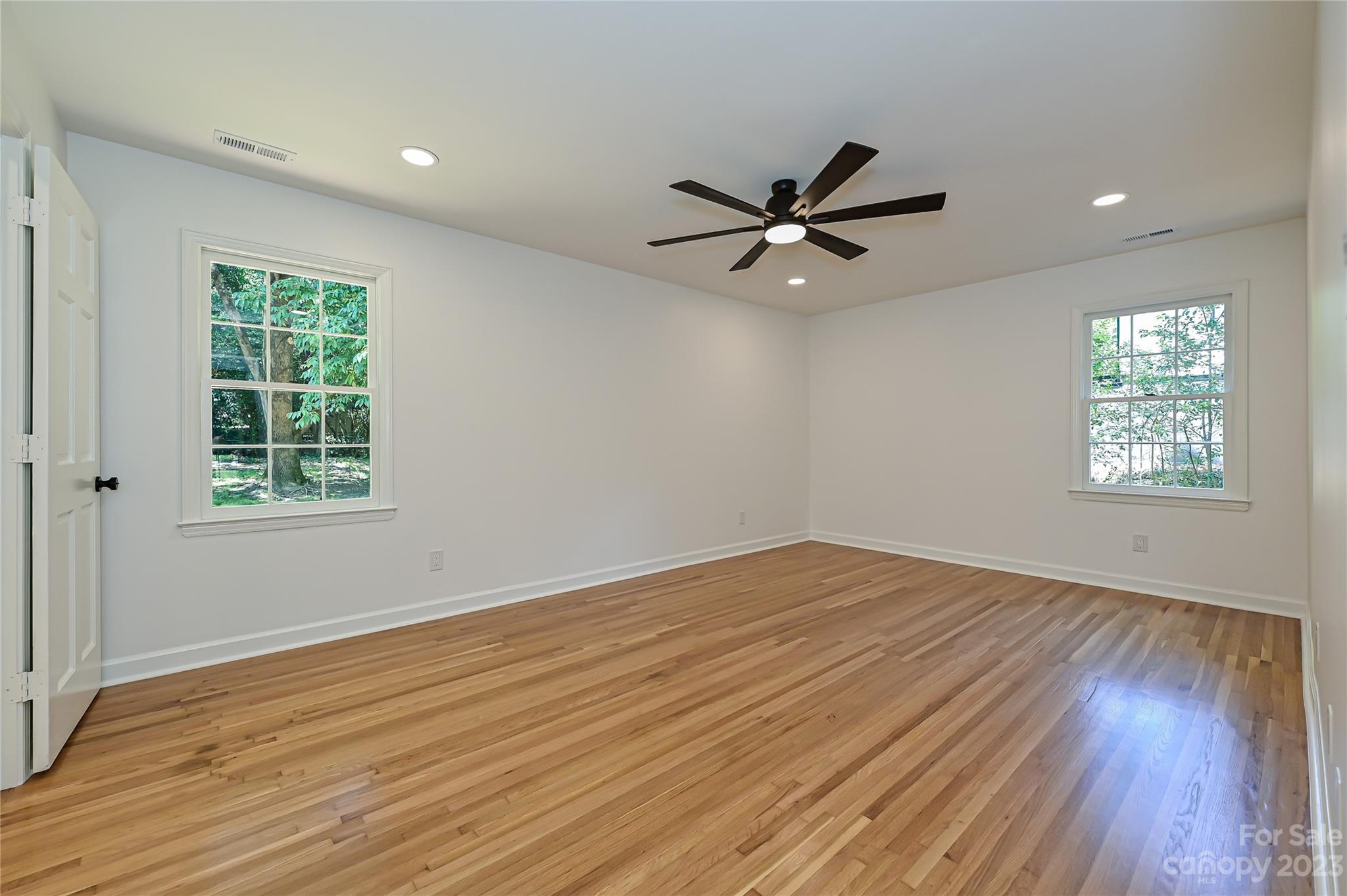 5024 Providence Road Charlotte, NC 28226 - Photo 21 of 39 an empty room with wooden floor fan and windows