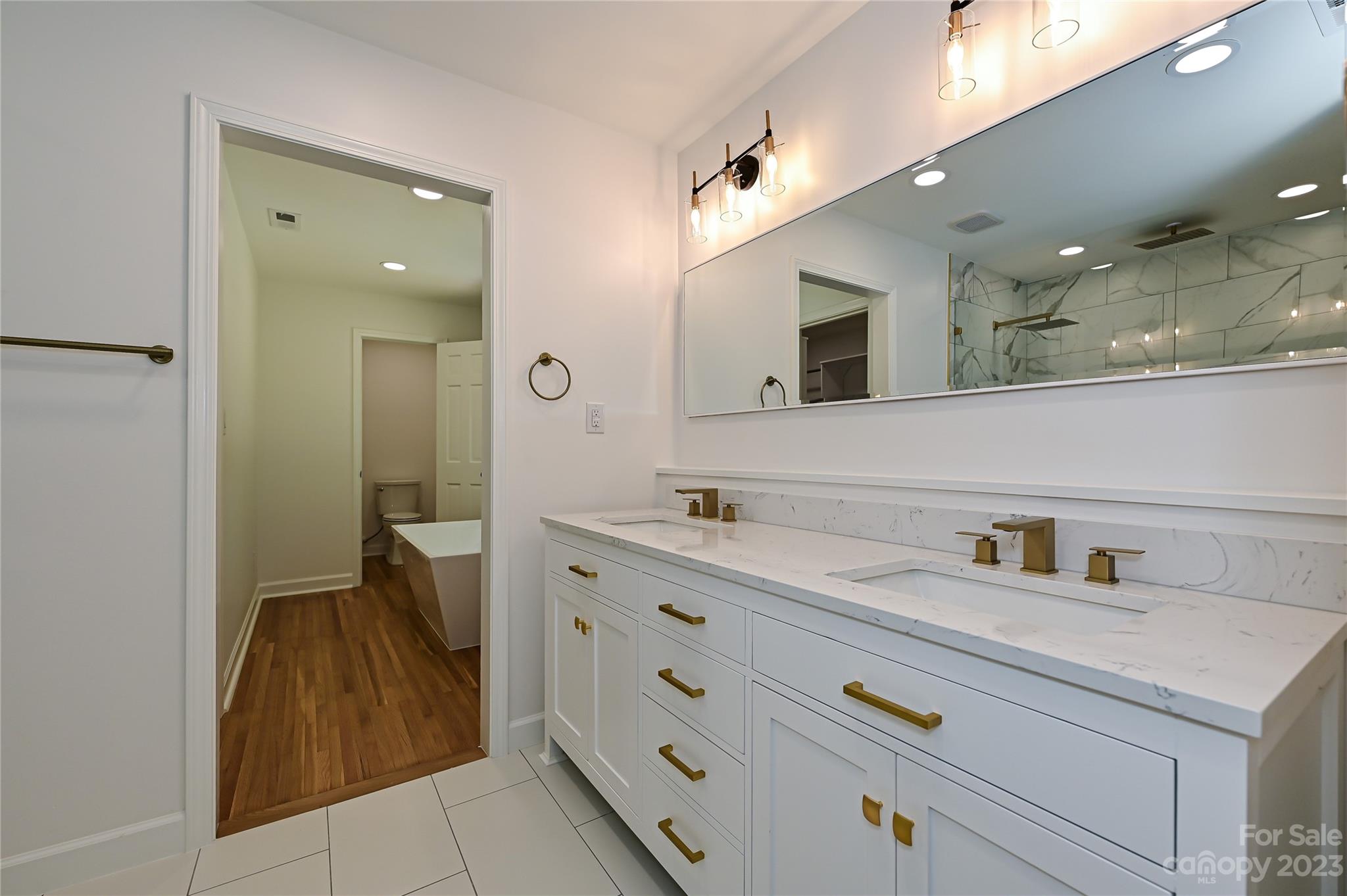 5024 Providence Road Charlotte, NC 28226 - Photo 24 of 39 a spacious bathroom with a sink and a mirror