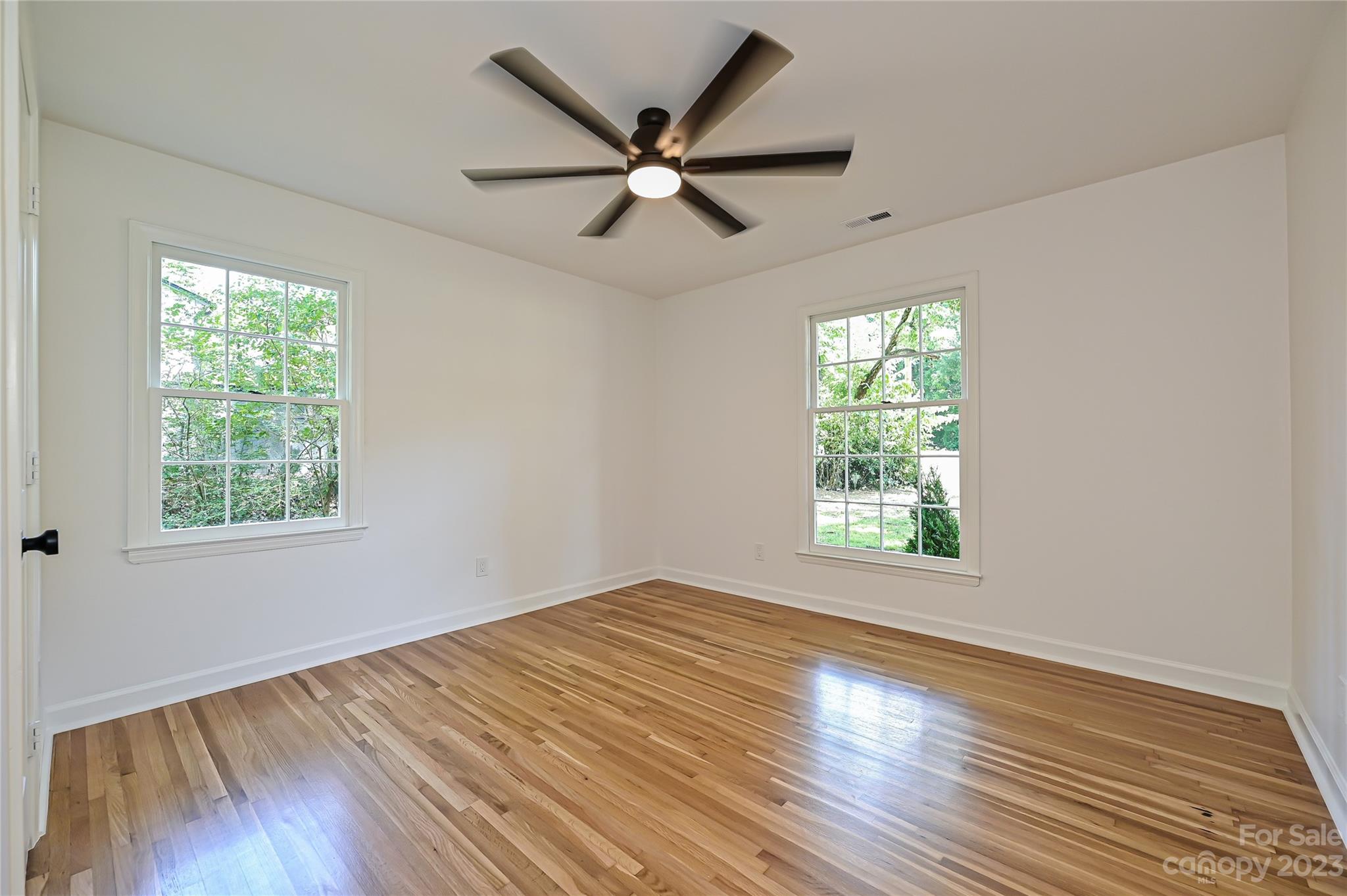 5024 Providence Road Charlotte, NC 28226 - Photo 29 of 39 an empty room with wooden floor windows and fan