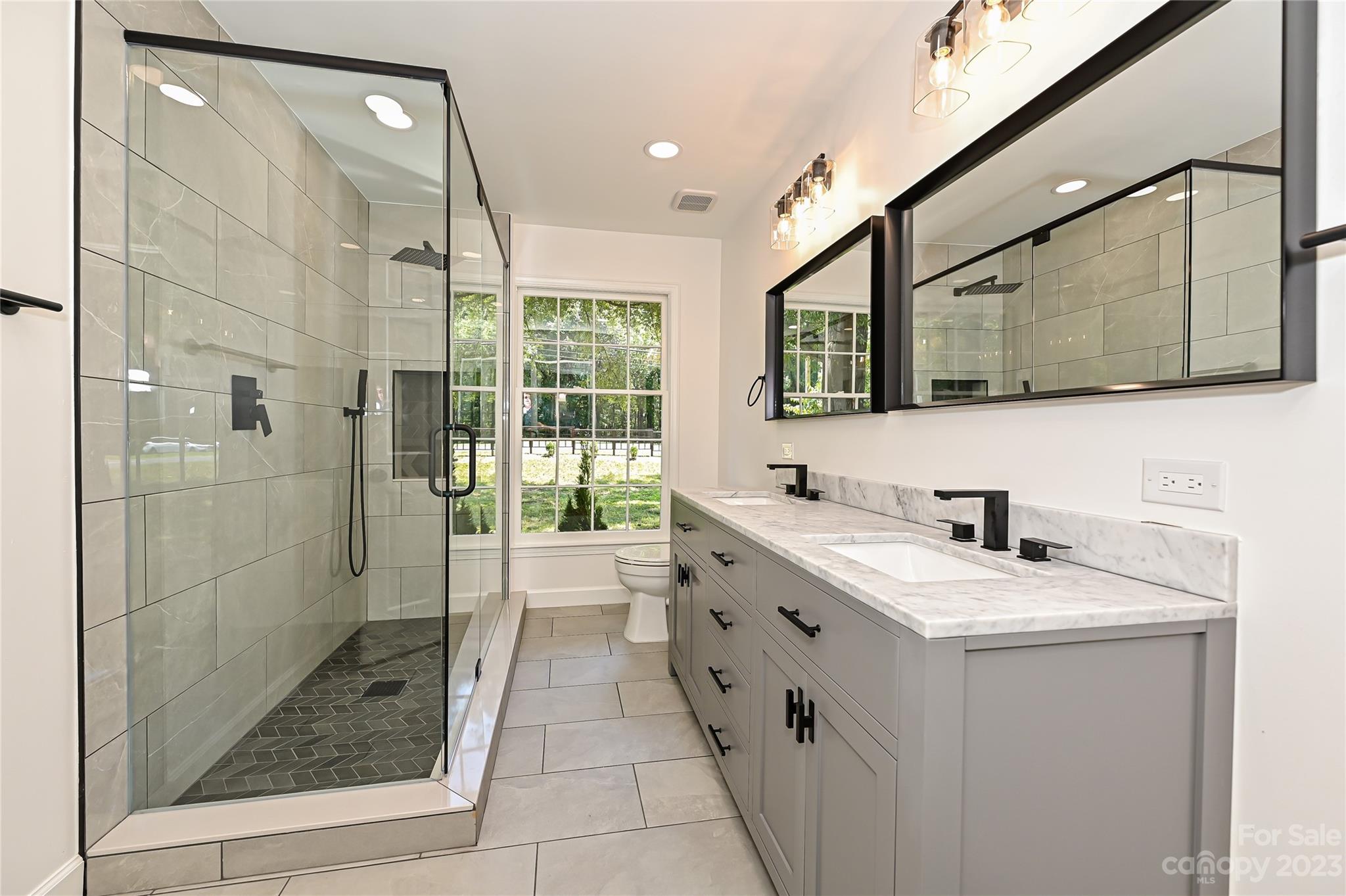 5024 Providence Road Charlotte, NC 28226 - Photo 31 of 39 a bathroom with a double vanity sink mirror and shower