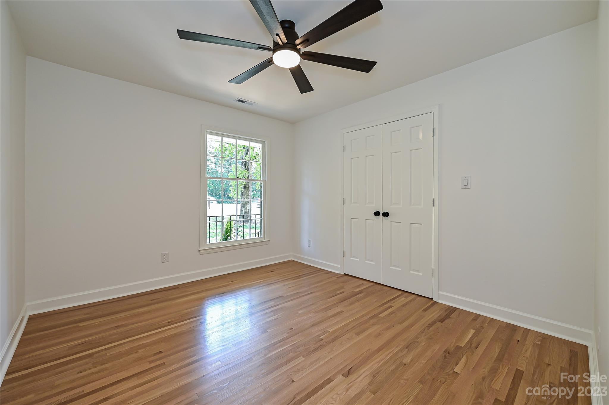 5024 Providence Road Charlotte, NC 28226 - Photo 32 of 39 a view of empty room with wooden floor and fan