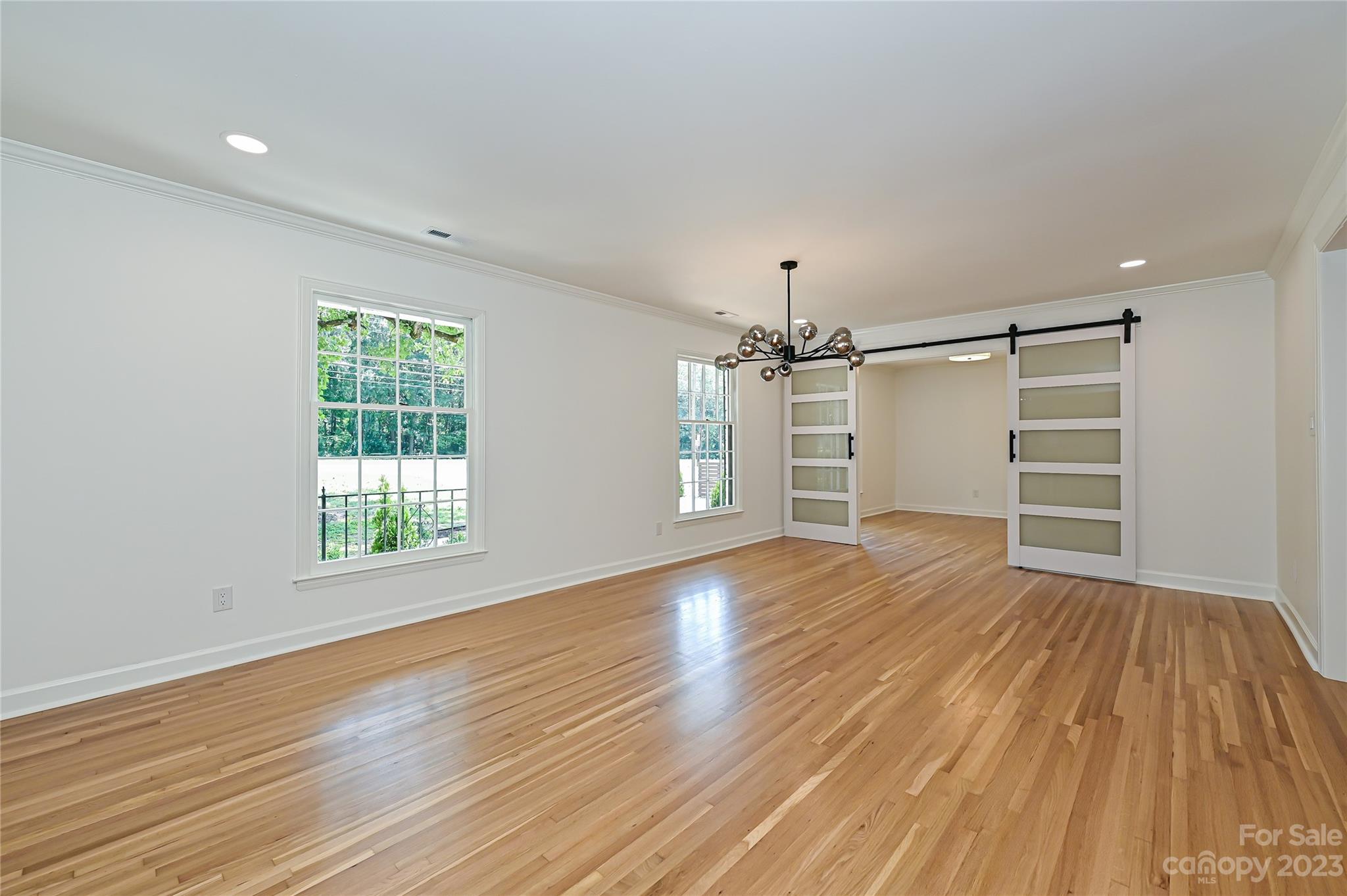 5024 Providence Road Charlotte, NC 28226 - Photo 5 of 39 an empty room with wooden floor closet and windows
