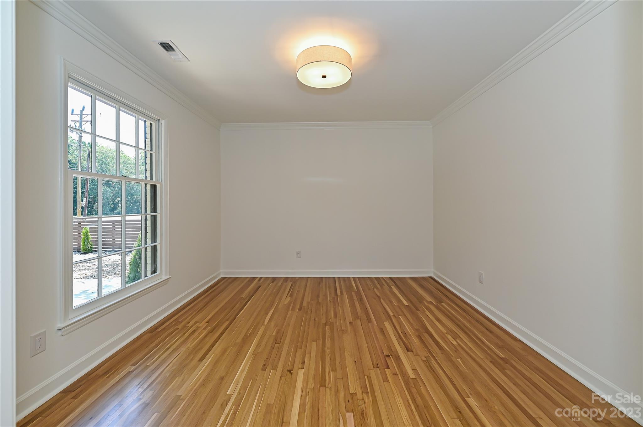 5024 Providence Road Charlotte, NC 28226 - Photo 7 of 39 a view of empty room with wooden floor and fan