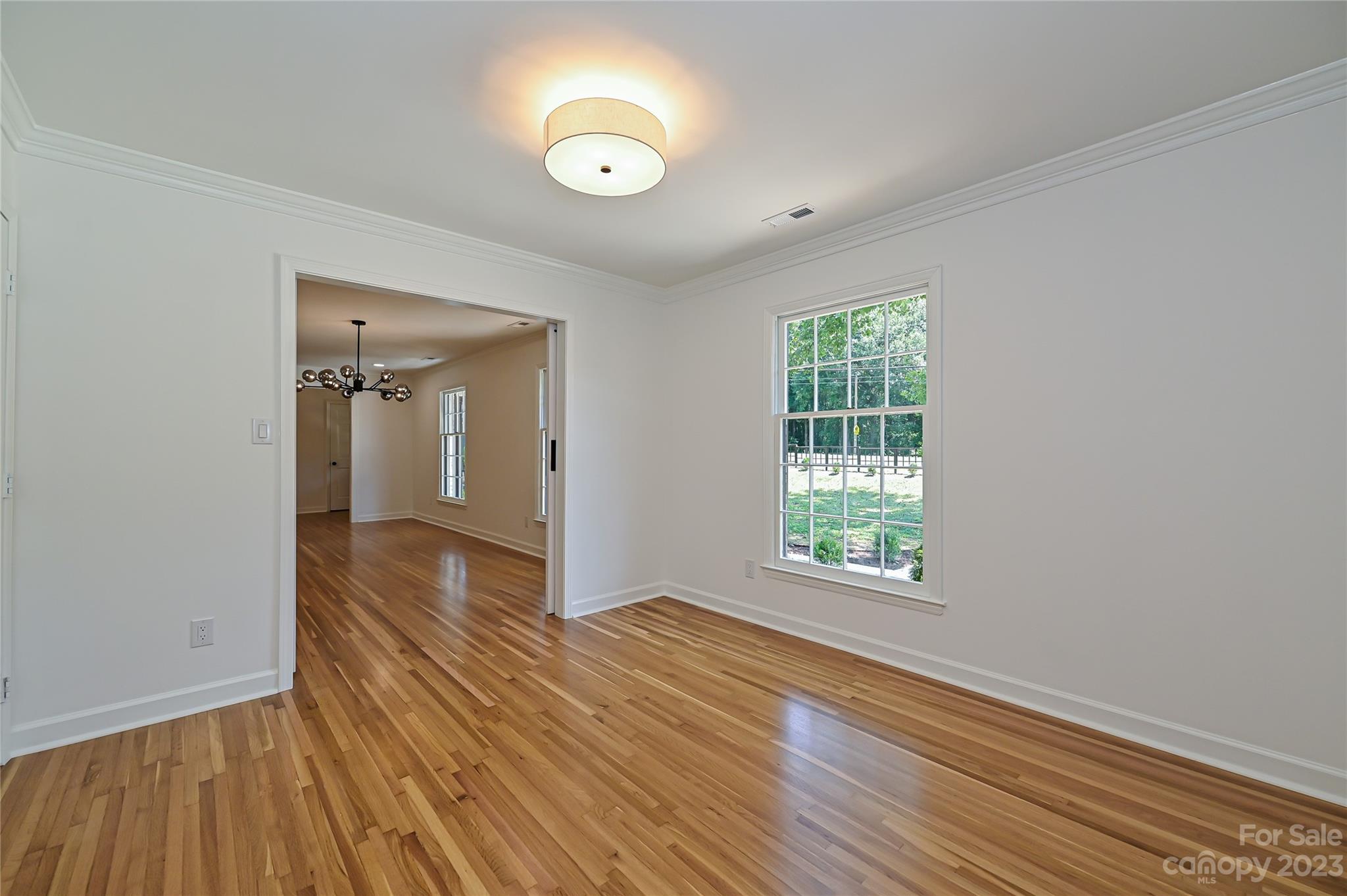 5024 Providence Road Charlotte, NC 28226 - Photo 8 of 39 a view of an empty room with wooden floor and a window