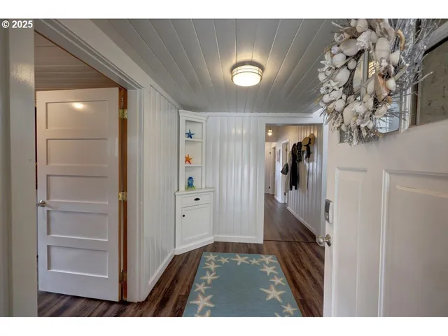 a view of hallway with wooden floor