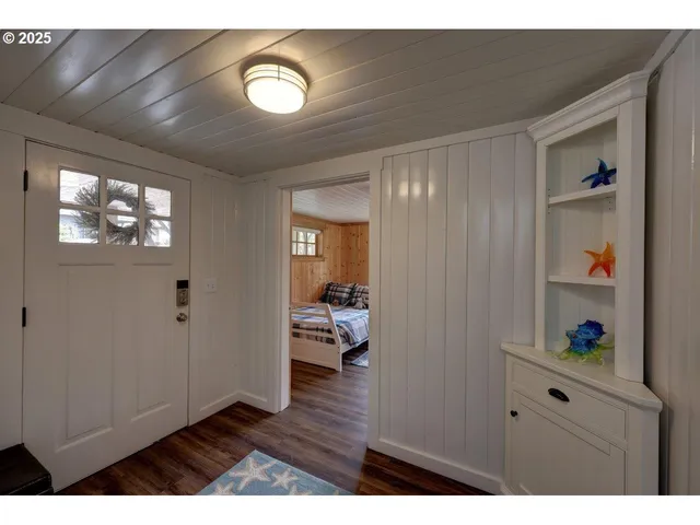 a view of an entryway with wooden floor