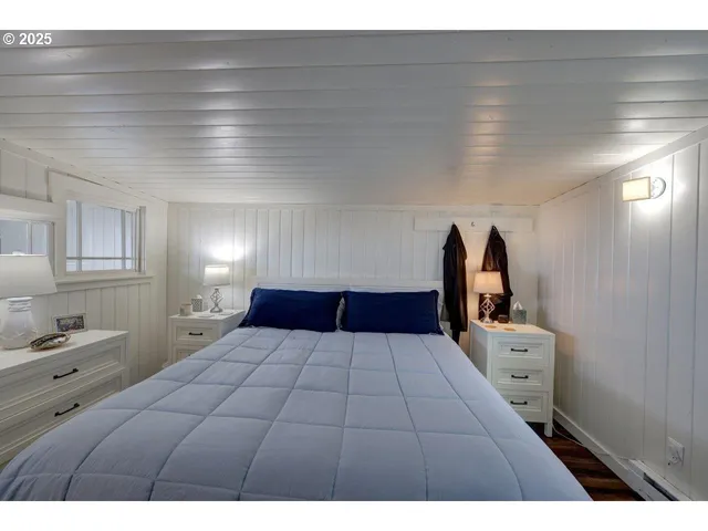 a bedroom with a large bed and a window