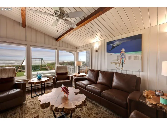 a living room with furniture a wooden floor and a large window