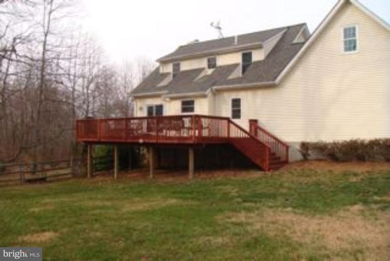 285 West Bay Front Road Lothian, MD 20711 - Photo 15 of 26 a front view of a house with a garden and deck
