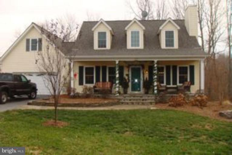 285 West Bay Front Road Lothian, MD 20711 - Photo 21 of 26 a view of a white house with a yard and large tree