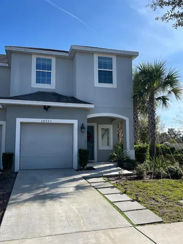 a view of a house with a yard and plants