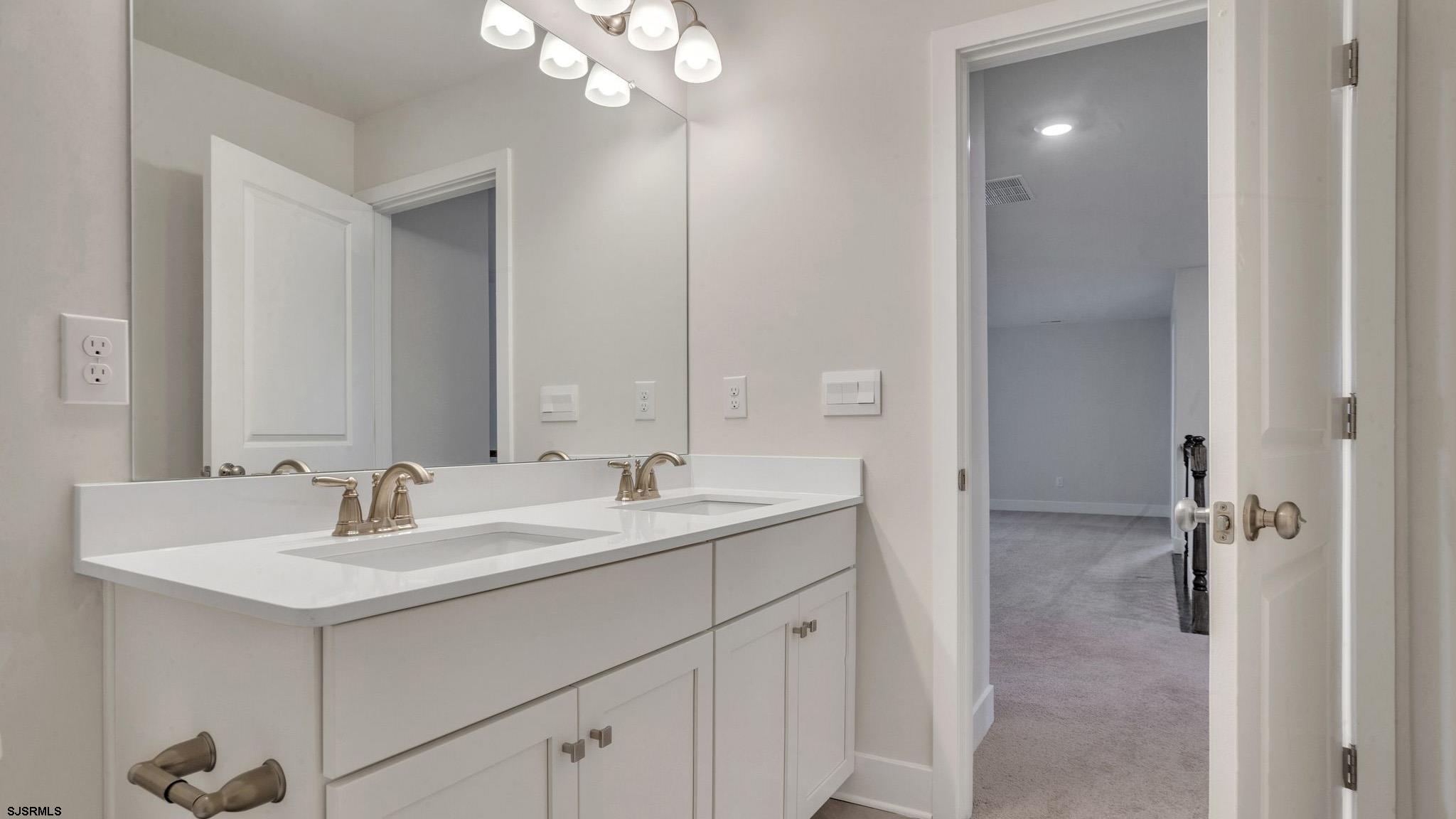 13 Henry Road Marmora, NJ 08223 - Photo 16 of 19 a bathroom with a sink double vanity and a mirror